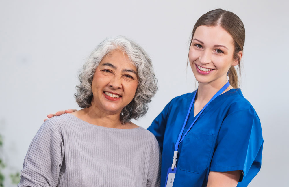 A woman and an older person smiling for the camera.